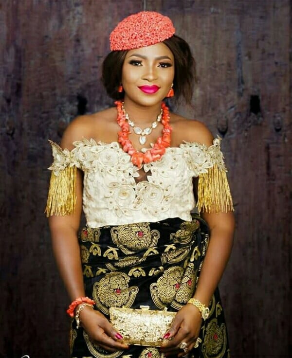 Bride In Off Shoulder Floral Embroidered Igbo Blouse With Gold Tassels and Isiagu Wrapper
